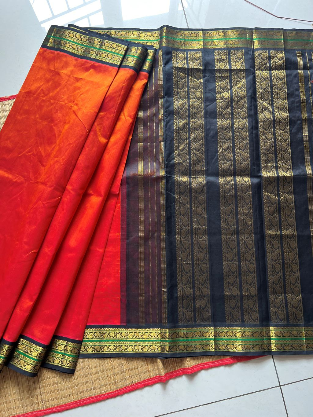 Burnt orange with black kodi border and pallu