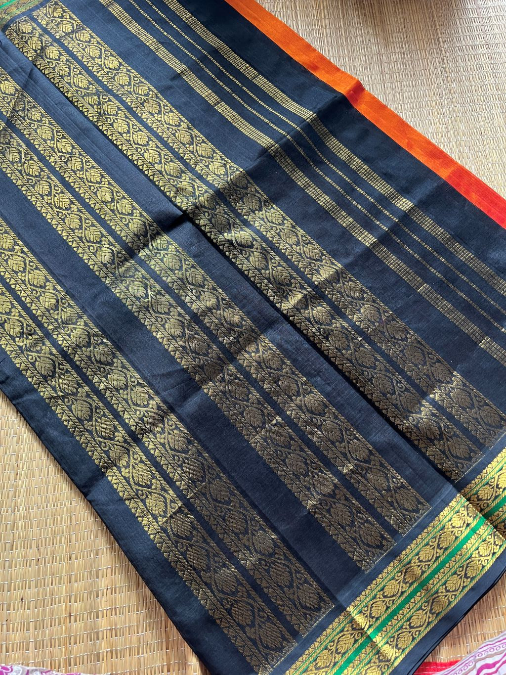 Burnt orange with black kodi border and pallu