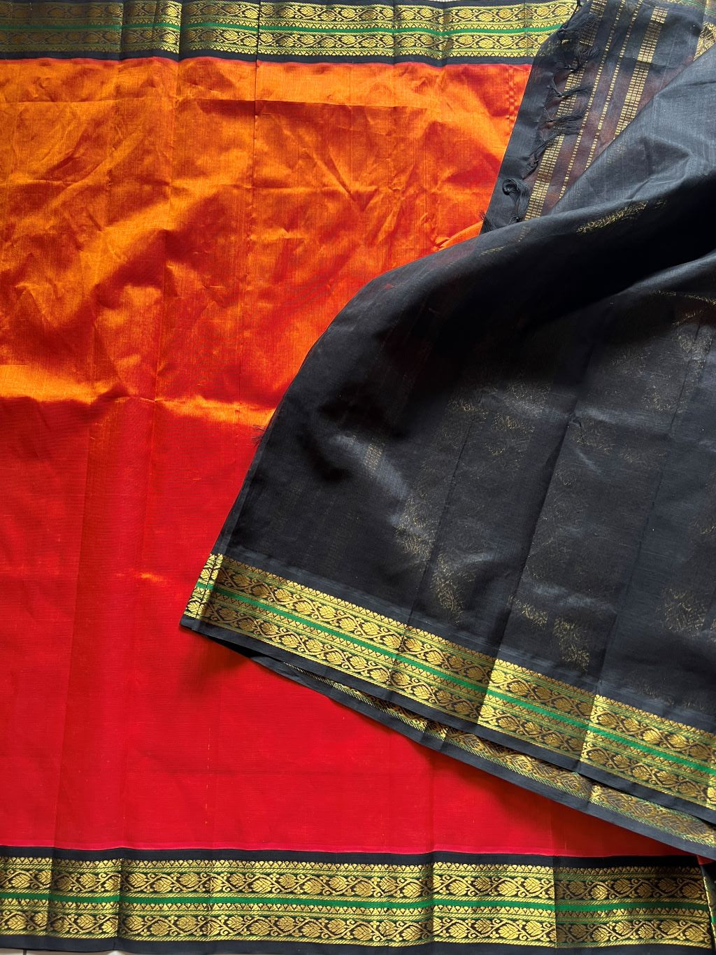 Burnt orange with black kodi border and pallu