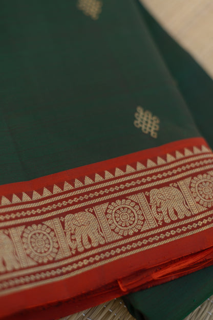 Green kolam saree with orange elephant border