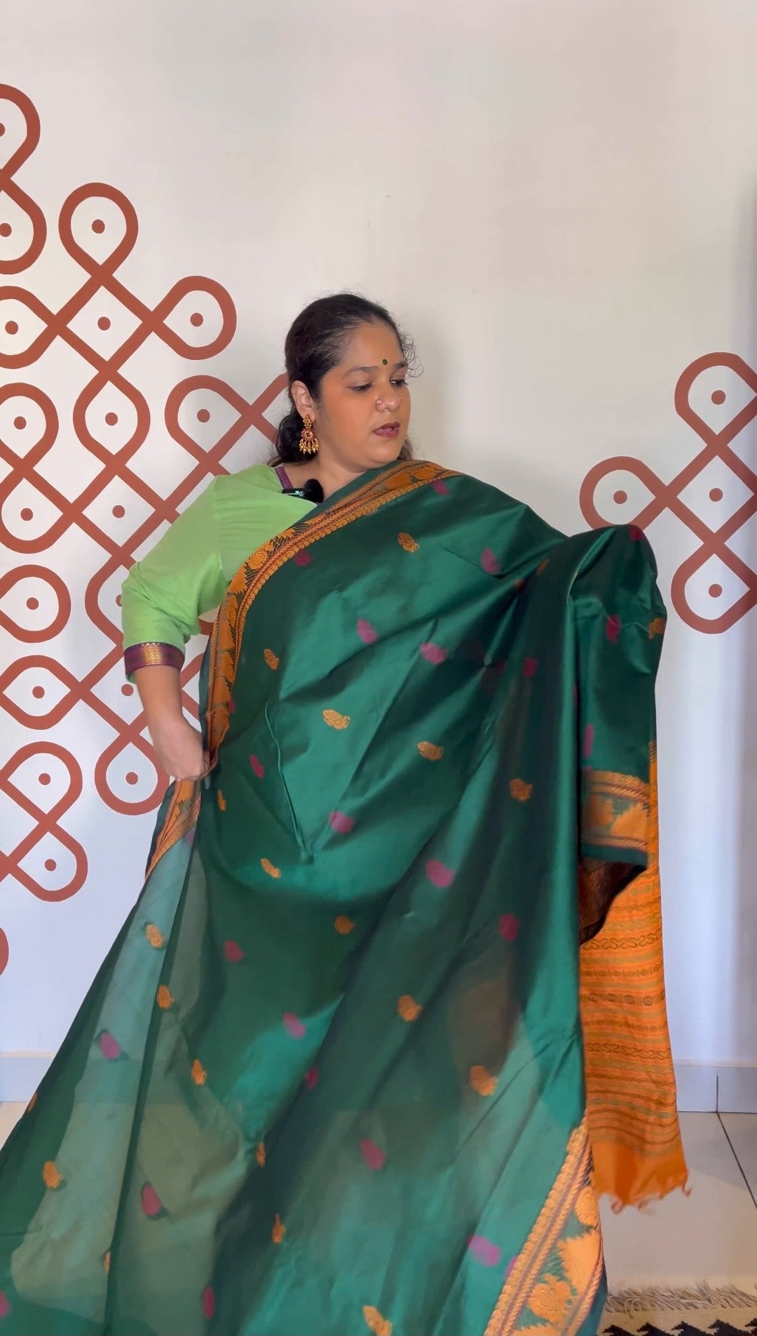 Meenakshi green with mustard peacock motifs thread border