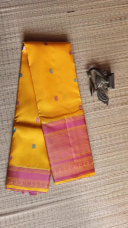 Turmeric Yellow with mauve pink thread work saree